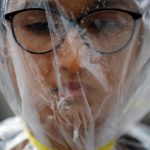An activist takes part in a demonstration to mark Earth Day by covering herself in a plastic sheet to protest against air pollution and muddy roads caused by what protesters say is a road expansion project in Kathmandu, Nepal.