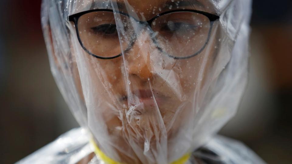 An activist takes part in a demonstration to mark Earth Day by covering herself in a plastic sheet to protest against air pollution and muddy roads caused by what protesters say is a road expansion project in Kathmandu, Nepal.