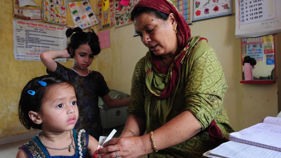 An anganwadi worker conducts a health checkup on a child in Bhopal. Anganwadis have been at the forefront of vaccination drives including the massive effort made towards vaccination against polio. As no new cases of polio were identified in India in the last two years, it is an effort that has come to fruition