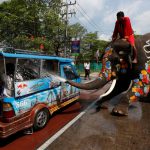 An elephant sprays tourists with water in celebration of the Songkran Water Festival in Ayutthaya province, north of Bangkok, Thailand, on April 11, 2017