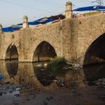 Barapullah, a causeway from the times of the early Mughal empire, is located near Nizamuddin Railway Station. Despite having a flyover corridor named after itself, today it supports a make shift market on top of itself while a sewer flows under it.