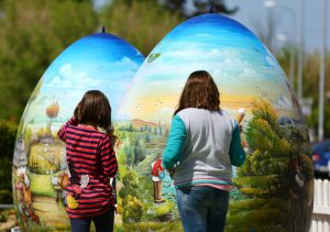 Children look at two-metre-high Easter eggs painted in the traditional naive art style in Koprivnica, Croatia, April 9