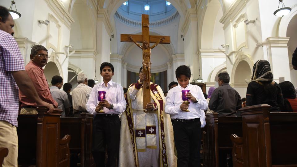 Christian devotees carry a huge cross on the occasion of ‘Good Friday’ at Sacred Heart Cathedral in New Delhi