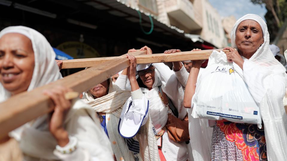 Christian pilgrims carry a wooden cross along the Via Dolorosa (Way of Suffering) in Jerusalem’s Old City during the Good Friday procession. For Christians, it is the most sorrowful, sombre and sacred day of the year. It is also referred as Holy Friday, Great Friday, Black Friday, or Easter Friday