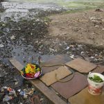 Clothes washing pile sits in a polluted field as world observes international Earth Day in Allahabad.