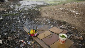Clothes washing pile sits in a polluted field as world observes international Earth Day in Allahabad.
