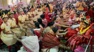 Devotees seeking blessings by touching feet of 'Kumari Kanya' (young girls) on the occasion of Ram Navami at Dakshineswar Ramkrishna Sangha Adyapeath, Dakshineswar, in Kolkata on Wednesday. More than 2000 girls participated in the Hindu festival that is observed after a nine days long fasting ritual