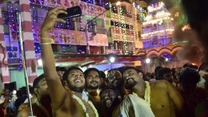 Devotees take selfies outside the Dharmaraya Swamy Temple in Bengaluru