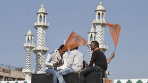 Hindu youth sit atop a truck before the start of the procession from Delhi’s Ramlila Maidan to Karol Bagh