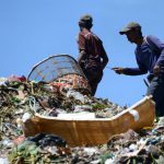 Indonesian scavengers carry items salvaged from a garbage dump in Denpasar. The theme for this year's Earth Day, which is marked on April 22, is Environmental and Climate Literacy.