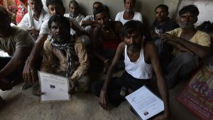 Mine workers show their Silicosis Certificates in Rajasthan, India. The Employee’s Compensation Act, 1923 recognises the risk of silicosis as an occupational hazard, mandating compensation for afflicted workers. Despite an amended law passed by Lok Sabha last year, workers struggle for compensation, saddled with the onus of diagnosis and then proving links to an occupational hazard.