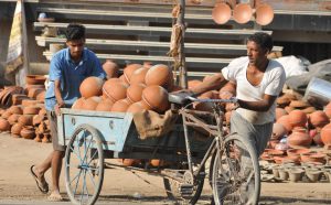 Potters taking earthen water coolers for sale in Mansoorwal village on the outskirts of Kapurthala