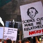 Protesters hold placards and banners as they participate in the March for Science rally on Earth Day, in central Sydney, Australia.