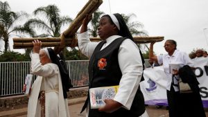 Religious leaders carry a cross during a silent Good Friday march in Durban, South Africa. The etymology of the term ‘good’ in Good Friday is contested in various circles