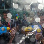 Revellers take part in a water fight at Songkran Festival marking the Thai new year celebrations in Bangkok streets on April 13, 2017. April being the hottest month of the year sees the entire country go bananas in friendly water fights and street parties that last nearly a week