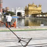 SGPC workers and devotees cool the floor in the parikarma (circumambulation) of the Golden Temple as the summer is already close to its peak in Amritsar on Friday, April 21, 2017