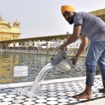 SGPC workers and devotees roll out mats and cool the floor in the parikarma (circumambulation) of the Golden Temple as the summer is already close to its peak in Amritsar on Friday, April 21.