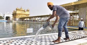 SGPC workers and devotees roll out mats and cool the floor in the parikarma (circumambulation) of the Golden Temple as the summer is already close to its peak in Amritsar on Friday, April 21.