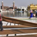 SGPC workers and devotees roll out mats and cool the floor with water from the sacred sarovar (pond) in the parikarma (circumambulation) of the Golden Temple as the summer is already close to its peak in Amritsar on Friday, April 21, 2017