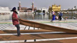 SGPC workers and devotees roll out mats and cool the floor with water from the sacred sarovar (pond) in the parikarma (circumambulation) of the Golden Temple as the summer is already close to its peak in Amritsar on Friday, April 21, 2017
