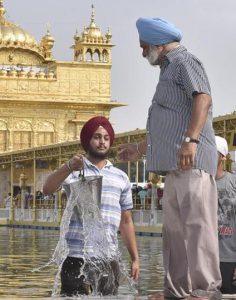 SGPC workers and devotees roll out mats and cool the floor with water from the sacred sarovar (pond) in the parikarma (circumambulation) of the Golden Temple as the summer is already close to its peak in Amritsar on Friday, April 21.