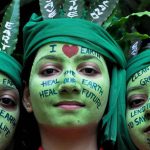 School girls with painted faces pose for a picture during 'Save Earth' awareness program on the eve of World Earth Day at a school in Moradabad, Uttar Pradesh.