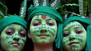 School girls with painted faces pose for a picture during 'Save Earth' awareness program on the eve of World Earth Day at a school in Moradabad, Uttar Pradesh.