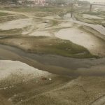 The dried up Ganga river basin at Sangam, winds through the confluence of the Ganges, Yamuna, and the mythical Saraswati River on the world Earth Day in Allahabad.