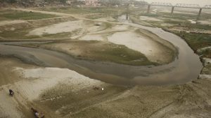 The dried up Ganga river basin at Sangam, winds through the confluence of the Ganges, Yamuna, and the mythical Saraswati River on the world Earth Day in Allahabad.