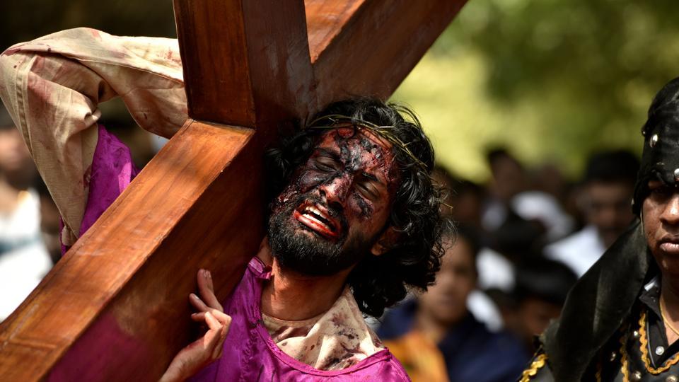 An artist enacts the crucifixion of Jesus on the occasion of Good Friday at Our Lady Lourdes Church at Cambridge Layout in Bengaluru, India