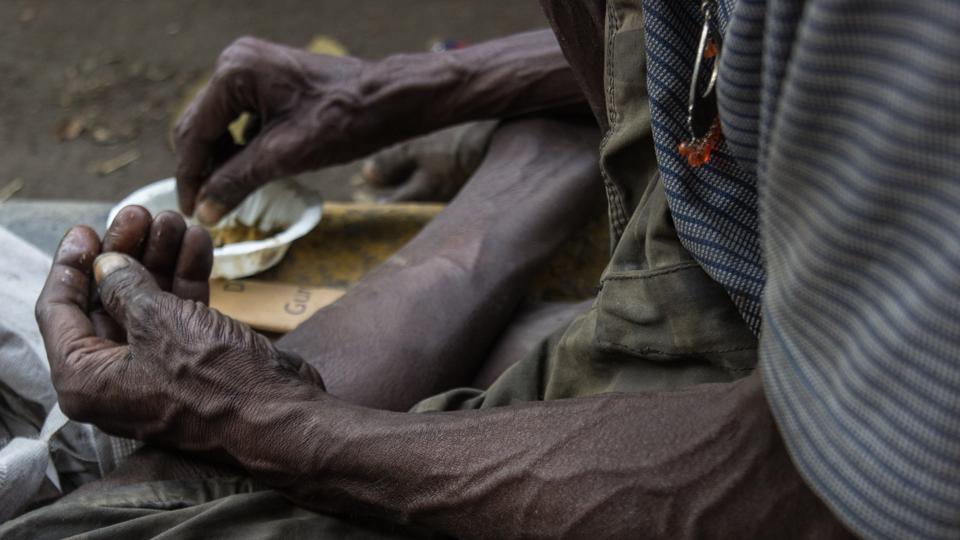 The hands of a man eating alms by the roadside. With 25% of all hungry people of the world living in India, malnutrition plagues the country. An estimated 194.6 million people in India are undernourished with 44% of children underweight and 72% infants anaemic