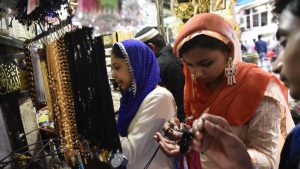 Visitors to the shrine buy religious items and trinkets at the shrine of Sufi saint Hazrat Khwaja Syed Nizamuddin Auliya
