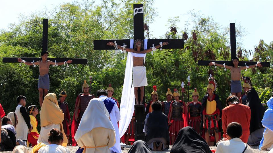 Willy Salvador (C), 60, who is portraying Jesus Christ, is nailed on a wooden cross during a Good Friday crucifixion re-enactment in San Juan village, Pampanga province, north of Manila, Philippines. Protestants, on the other hand, do not have food restrictions on Good Friday but many follow the ‘no meat’ rule like the Catholics