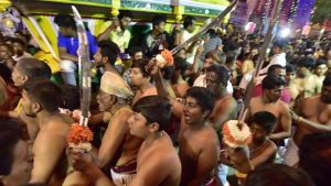 Youngsters inside the temple with customary swords on the occasion of Karaga at Dharmaraya Swamy Temple in Bengaluru