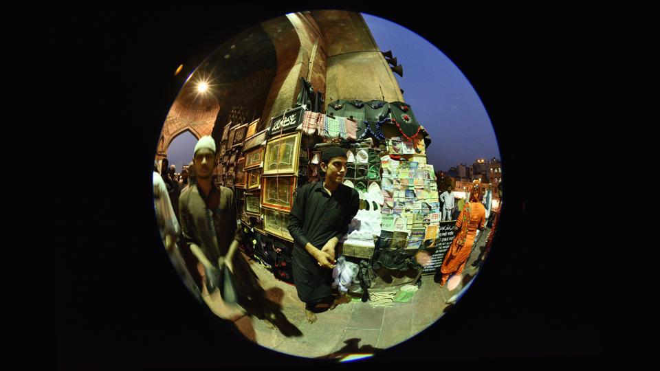 A Muslim man in his makeshift stall outside the Jama Masjid entry, selling Ramzan essentials.