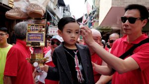 A boy depicts Hong Kong Chief Executive Leung Chun-ying during the Bun Festival parade.