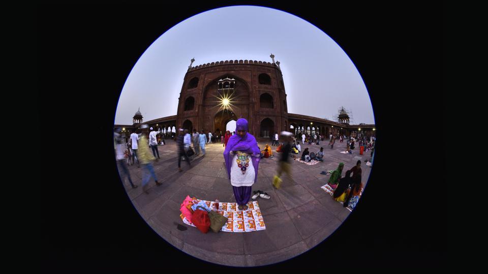 A muslim woman offers evening prayers at the Jama Masjid on the 3rd day of Ramzan.