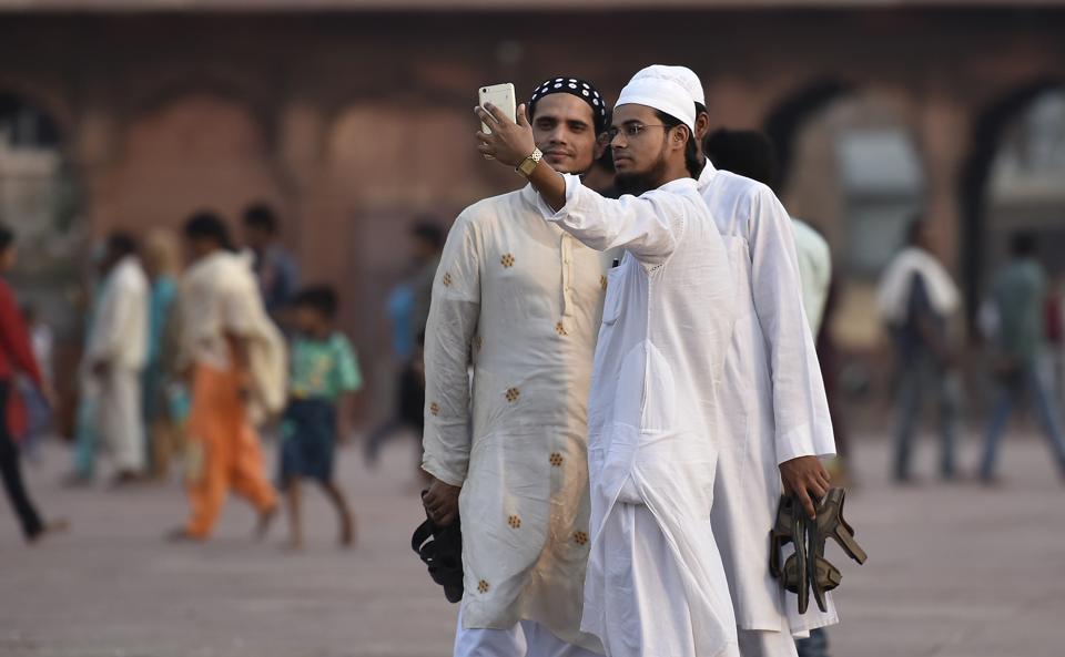 Muslims men take selfie after offering prayers on the first day of Ramzan at Jama Masjid, New Delhi.