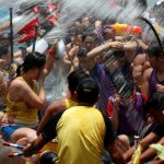 Participants splash water during a ceremony in between races during Tung Ng or Dragon Boat Festival.
