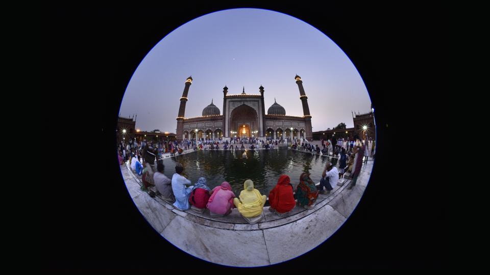 People wash their hands in a pond before their evening prayers outside Jama Masjid, the largest mosque in India.