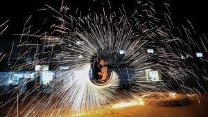 A Palestinian man plays with fire crackers celebrating Ramadan at the town of Rafah in the southern Gaza Strip.