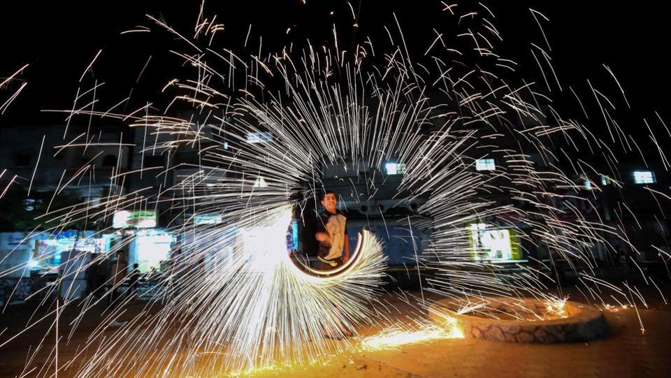 A Palestinian man plays with fire crackers celebrating Ramadan at the town of Rafah in the southern Gaza Strip.