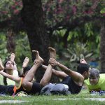 A group strikes a yoga pose at Lodhi Garden in New Delhi on June 18, 2017.