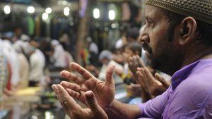 A man raises his hands in prayer during Juma-tul-Wida in Kolkata, West Bengal