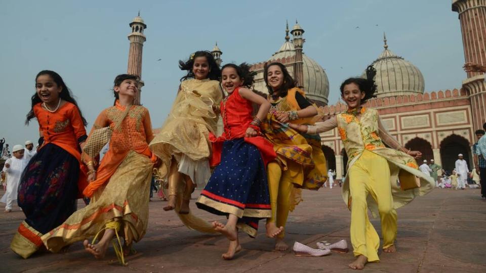 Children greet each other on the occasion of Eid-ul-Fitr at Jama Masjid in New Delhi