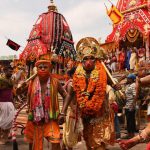 Devotees dressed up as various mythological figures near the main gate of the Puri temple
