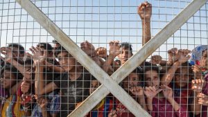 Displaced Iraqi children gather behind a fence at the Hasan Sham camp for internally displaced people. According to a new report by the United Nations High Commissioner for Refugees (UNHCR), a record 65.6 million people worldwide were forcibly displaced from their homes due to conflict or persecution by the end of 2016. The number marks a jump of 300,000 from the end of 2015. ‘This equates to one person becoming displaced every three seconds - less than the time it takes to read this sentence’ the United Nations report said.