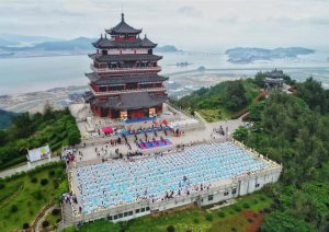 Participants practice yoga at the third International Day of Yoga celebrations at Dongtou Wanghai Pavilion in Wenzhou in China’s Zhejiang on June 19, 2017. Wenzhou (Dongtou) became the sixth city in the Eastern China region to host Yoga Day celebrations.
