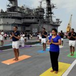 People from the Naval staff perform yoga during a mass yoga event to mark the 3rd International Yoga Day on the deck of former warship INS Viraat at the Naval dockyard in Mumbai on June 21.