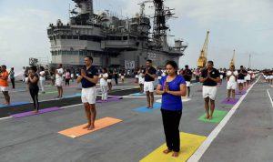 People from the Naval staff perform yoga during a mass yoga event to mark the 3rd International Yoga Day on the deck of former warship INS Viraat at the Naval dockyard in Mumbai on June 21.